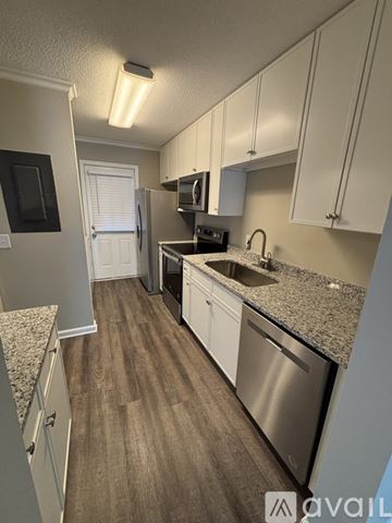 St. Simons Island apartment for rent - A kitchen with white cabinets and a granite countertop.