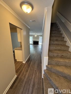 St. Simons Island apartment for rent - A hallway with a staircase on the right and a door on the left.