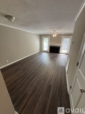 St. Simons Island apartment for rent - A room with wooden flooring and a ceiling fan.
