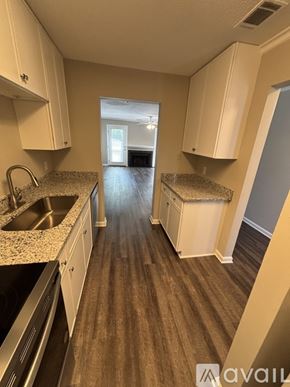 St. Simons Island apartment for rent - A kitchen with white cabinets and a sink.