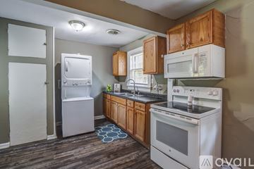 Lynchburg apartment for rent - A kitchen with a white stove top oven and a white refrigerator.