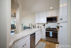Oceanside apartment for rent - A kitchen with white cabinets and a stainless steel oven.