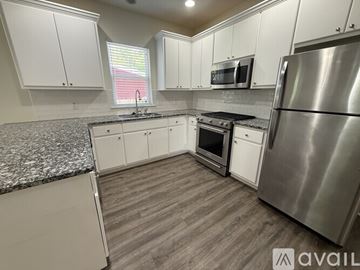 Santa Rosa Beach apartment for rent - A kitchen with white cabinets and a granite countertop.