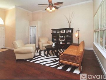 Gotha apartment for rent - A living room with a zebra print rug and a black bookcase.