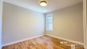 Chicago apartment for rent - A hallway with a white door on the right and a black door on the left.