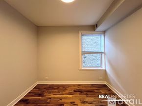 Chicago apartment for rent - A white dryer is sitting next to a white door in a room.