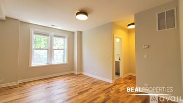 Chicago apartment for rent - A kitchen with white cabinets and a stainless steel refrigerator.