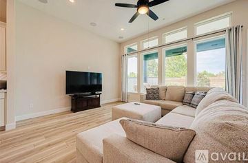 Harris County apartment for rent - A living room with a television and a couch.