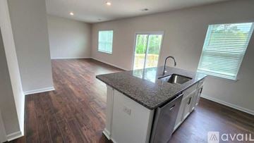 Asheville house for rent - A kitchen with a granite countertop and stainless steel appliances is available for rent.