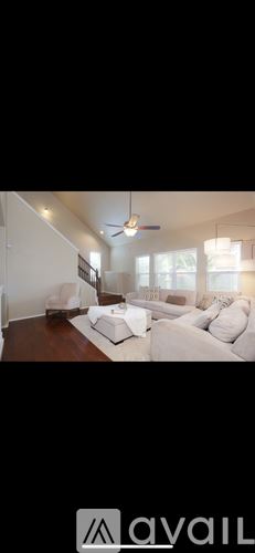 San Antonio house for rent - A living room with a white couch and a ceiling fan.