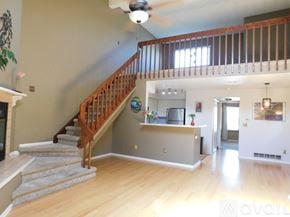 Aurora apartment for rent - A bedroom with a bed, a TV, and a window with blinds.