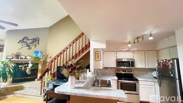 Aurora apartment for rent - A kitchen with a staircase and a dining table.