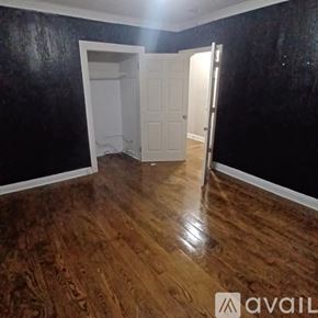 East Cleveland apartment for rent - A white bathroom with a hole in the wall.