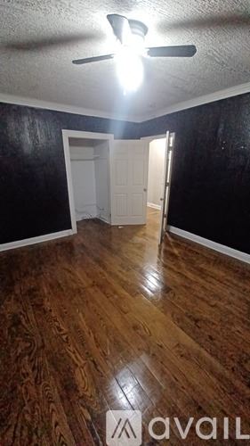 East Cleveland apartment for rent - A room with a ceiling fan and a door.
