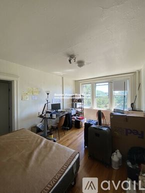 Boston apartment for rent - A room with a bed, a desk, and a window.