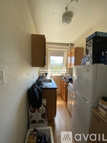 Boston apartment for rent - A kitchen with a refrigerator, sink, and cabinets.