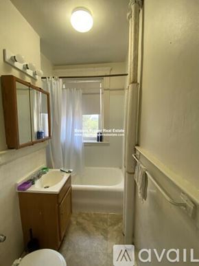 Boston apartment for rent - A bathroom with a toilet, sink, and bathtub.