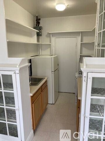 Boston apartment for rent - A small kitchen with a sink and a refrigerator.