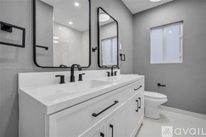 Miami house for rent - A bathroom with a white sink and a toilet.