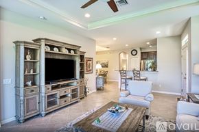 Fort Myers house for rent - A living room with a large entertainment center and a couch.