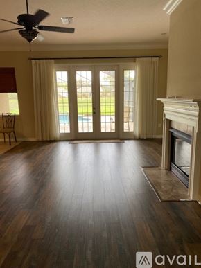 Brooksville house for rent - A living room with a fireplace and sliding glass doors.