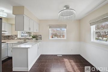 Ann Arbor house for rent - A kitchen with white cabinets and a large island.