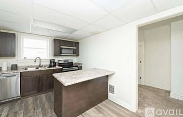 St. Joseph apartment for rent - A kitchen with a stainless steel dishwasher and a microwave above the counter.
