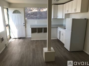 Spring Valley apartment for rent - A kitchen with white cabinets and a wooden floor.