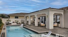 Indian Wells apartment for rent - A modern house with a pool in the backyard.