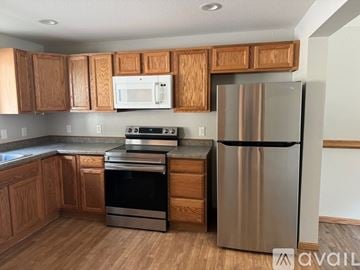 Mankato apartment for rent - A kitchen with wooden cabinets and a stainless steel refrigerator.
