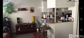 San Antonio apartment for rent - A room with a chair, a table, and a cabinet.