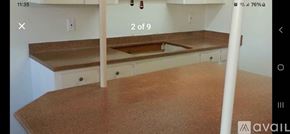 San Antonio apartment for rent - A kitchen counter with a brown countertop and white cabinets.