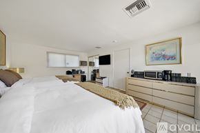 Indian Wells apartment for rent - A bedroom with a large bed and a painting on the wall.
