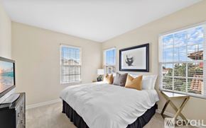 Newport Beach apartment for rent - A bedroom with a large bed and a television.