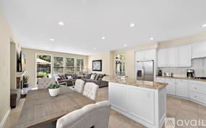 Newport Beach apartment for rent - A modern kitchen with white cabinets and a large island.