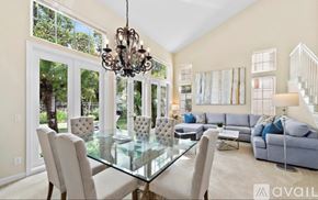 Newport Beach apartment for rent - A modern dining room with a glass table and chairs.