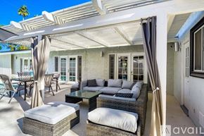 Palm Desert house for rent - A sunny day at the patio with white furniture.
