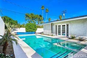 Palm Desert house for rent - A pool in front of a house with a sign that says "available".