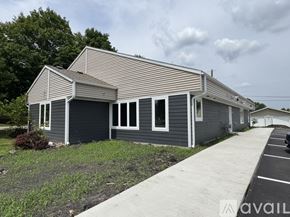 Nicollet apartment for rent - A house with a grey exterior and a striped roof is available for rent.