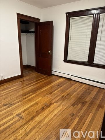 Saugus apartment for rent - A room with wooden flooring and a door leading to another room.