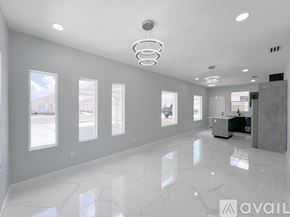 Edinburg apartment for rent - A spacious, well-lit room with a marble floor and a large mirror on the wall.