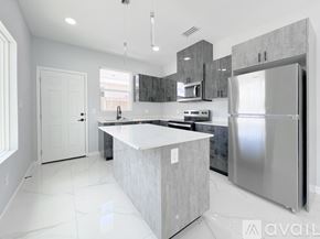 Edinburg apartment for rent - A modern kitchen with a large island and stainless steel appliances.