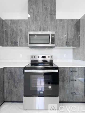 Edinburg apartment for rent - A modern kitchen with a stove and microwave above it.