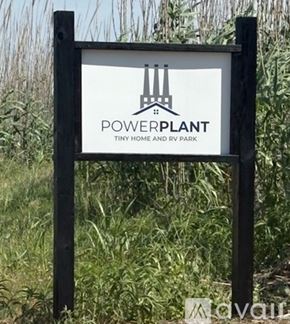 Fayetteville apartment for rent - A sign for Powerplant Tiny Home and RV Park stands in a field.