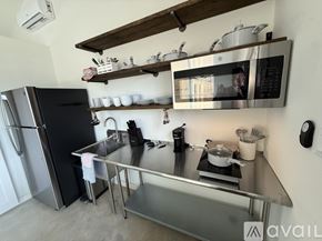 Fayetteville apartment for rent - A modern kitchen with a stainless steel refrigerator and microwave above a stove.