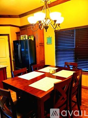 Oklahoma City apartment for rent - A dining room with a wooden table and chairs.