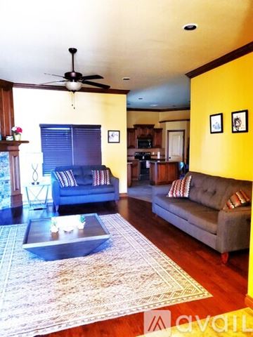 Oklahoma City apartment for rent - A living room with a grey couch and a coffee table.