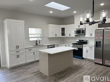 Socorro apartment for rent - A modern kitchen with white cabinets and a central island.