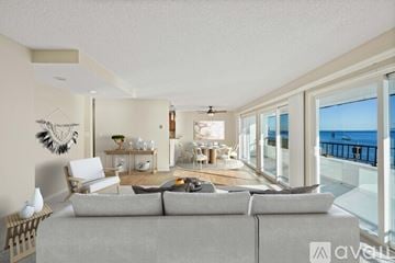 Malibu apartment for rent - A living room with a grey couch and a view of the sea.