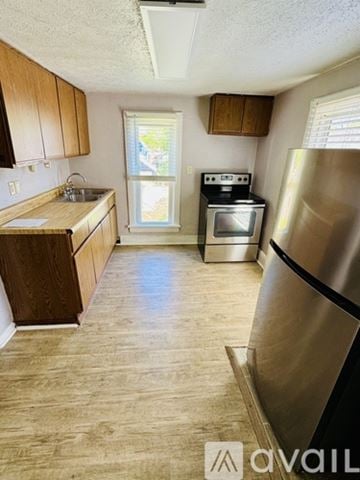 St. Joseph apartment for rent - A kitchen with wooden cabinets and a stainless steel refrigerator.